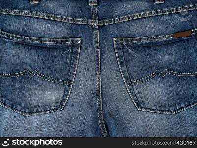 back pocket on blue jeans, full frame, close up