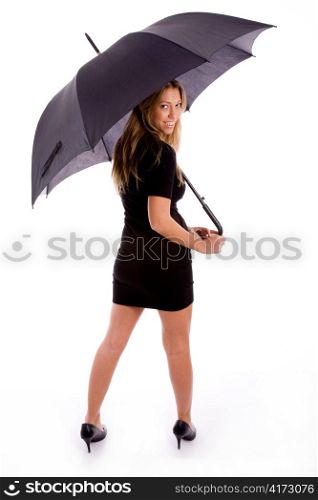 back pose of smiling female carrying umbrella on an isolated white background
