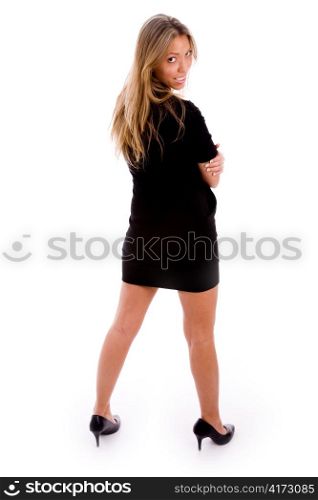 back pose of young standing model against white background