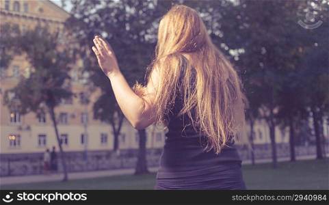 Back side of the torso shot. Walking in loneliness. Portrait of a beautiful girl in the park. Autumn.