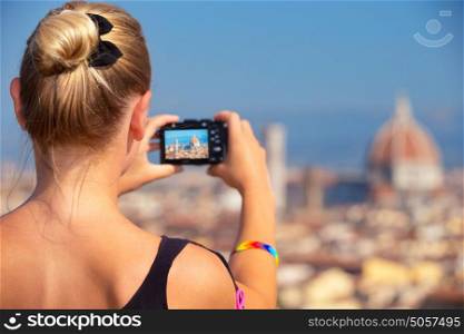 Back side of woman photographing majestic cityscape, Europe, Florence, Italy, Tuscany, travel and tourism concept