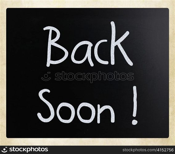 ""Back soon!" handwritten with white chalk on a blackboard"