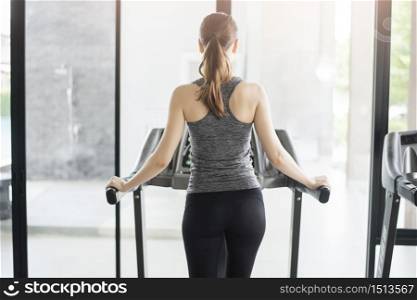 Back sport woman jogging on treadmill in gym, Healthy lifestyle