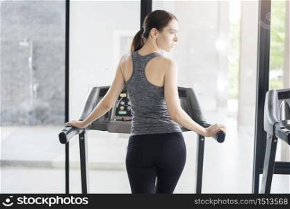 Back sport woman jogging on treadmill in gym, Healthy lifestyle