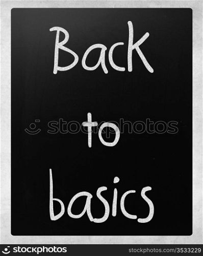 ""Back to basics" handwritten with white chalk on a blackboard"