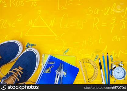 back to school border - blue shoes with school supplies with math formulas. back to school