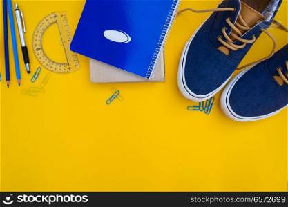 back to school border - pair of blue shoes with school supplies. back to school