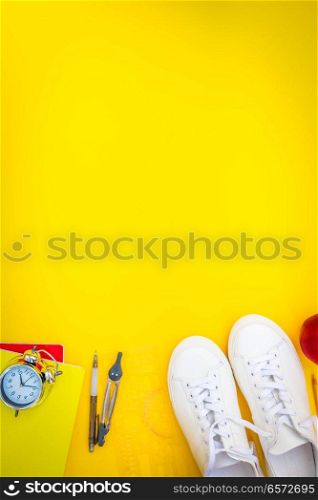 back to school border - pair of white shoes with school supplies, retro toned. back to school