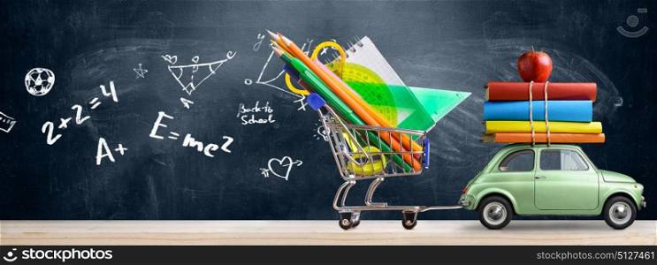 Back to school car.. Back to school sale background. Car delivering shopping cart full of accessories, books and apple against blackboard with education symbols.