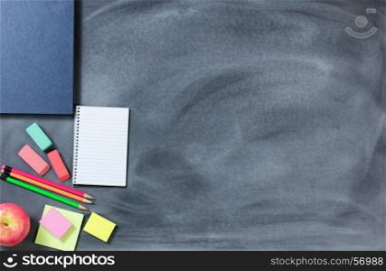 Back to School chalk board with apple and writing materials