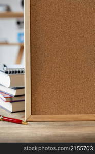 Back to school concept. Cork board frame background at table in office. Student home workplace