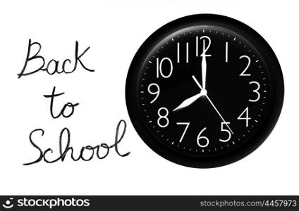 Back to school concept, handwriting on a white chalkboard with big black clock