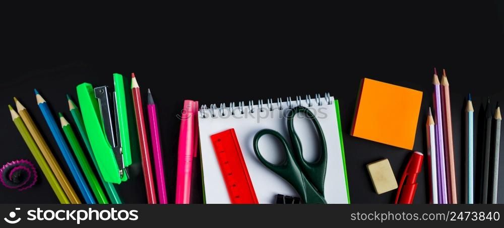 Back to school concept. Office supplies on a chalkboard background. Place for text. Banner format. Back to school concept. Office supplies on chalkboard background. Banner format