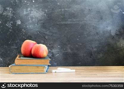 Back to school concept with apples and chalk on blackboard background with copy space. back to school
