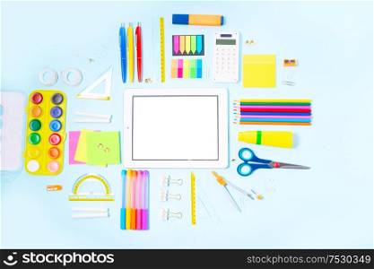 Back to school concept with school supplies on blue background, copy space on empty screen. back to school