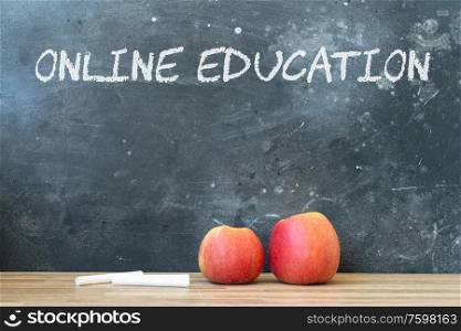 Back to school concept with two red apples and chalk. copy space on blackboard. School and online education background.. back to school