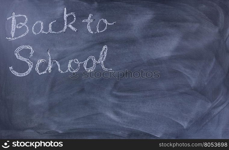 Back to school concept with written message on left hand side of chalkboard.