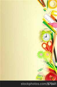 Back to School Conceptl: alarm clock, scissors, rulers, cutter, pencils, markers, paperclips, sharpener, scotch tape and red apple on the Yellow Background