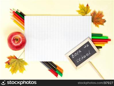 Back to School Conceptl: Colorful Felt Pens and Pencils, Sheet of Paper, Red Apple and Mapple Leaves on the Yellow Background