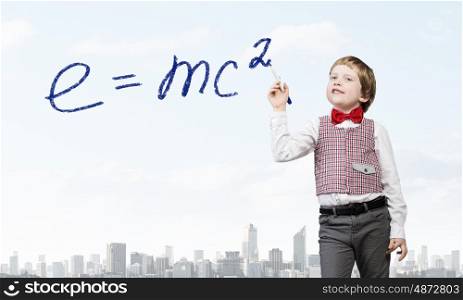 Back to school. Cute boy drawing science formula on screen