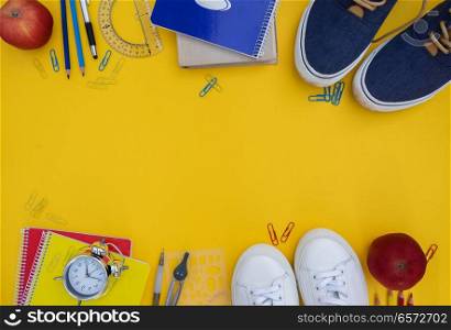 back to school frame- shoes with school supplies on yellow. back to school