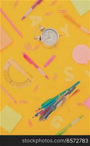 back to school or office styed pattern scene with multicolored school supplies on yellow, retro toned. back to school