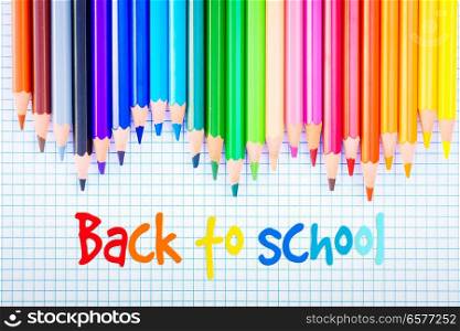 Back to school pencils rainbow on ruled paper with back to school greeting. Back to school pencils