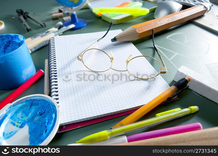 back to school still life on blackboard with teacher glasses pencil paint and several education stuff