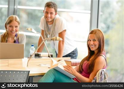 Back to school students studying in library smiling learning education