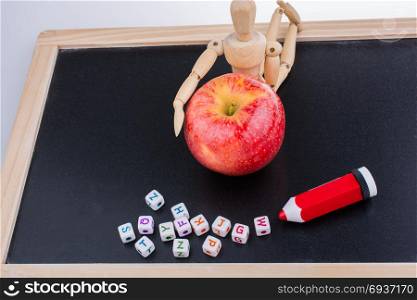 Back to school theme with a red apple and board