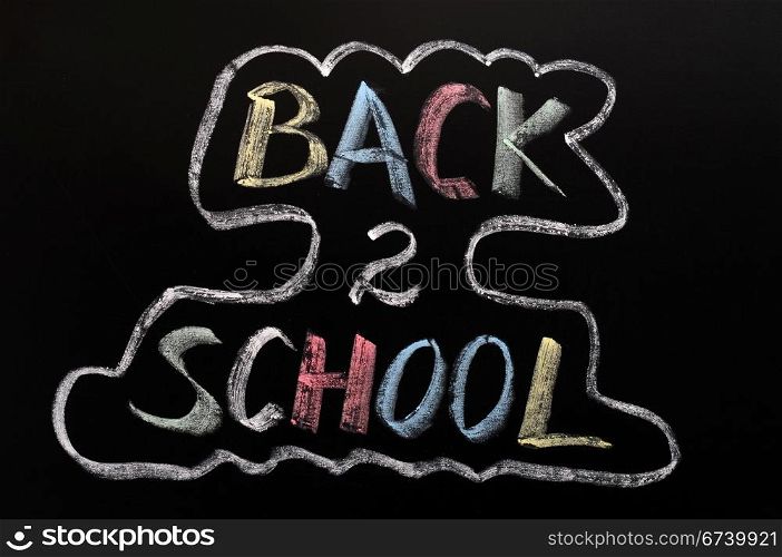 Back to school written in colorful chalk on a blackboard