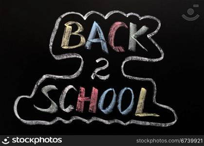Back to school written in colorful chalk on a blackboard