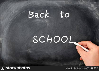 Back to school written on a blackboard with white chalk