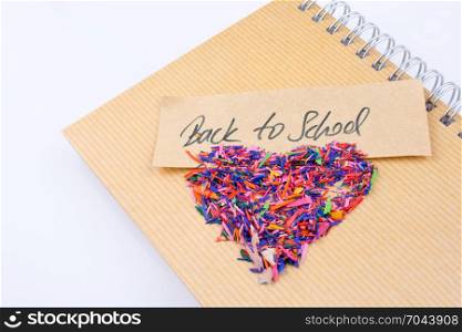 Back to school written title and a heart shape on a notebook