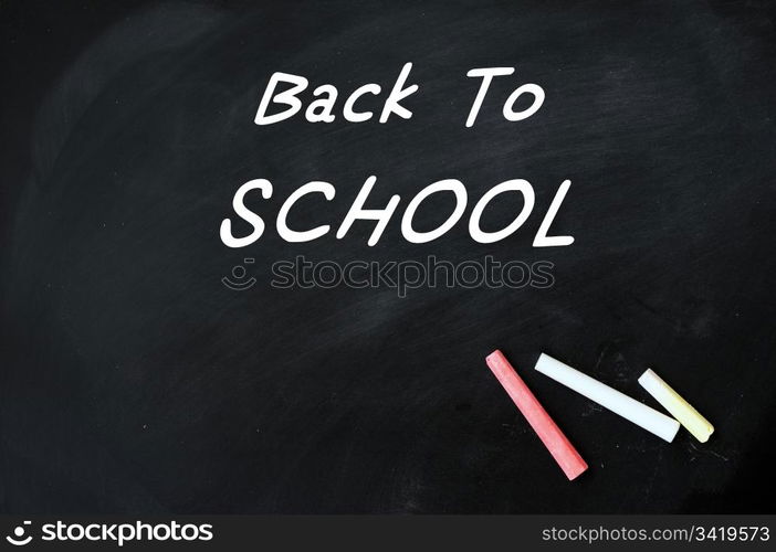 Back to school written with white chalk on a blackboard