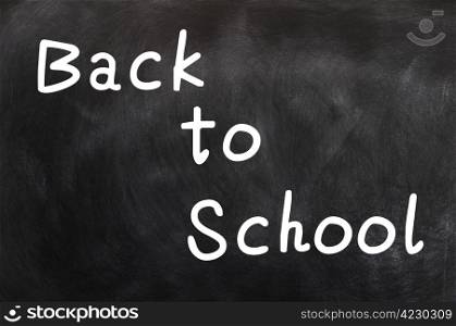 Back to school written with white chalk on a blackboard