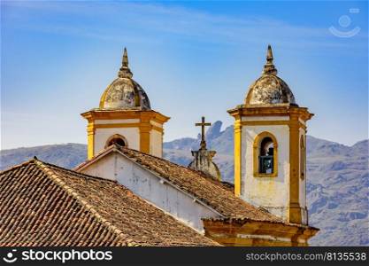 Back view at night of old and historic church in colonial architecture from the 18th century in the city of Ouro Preto in Minas Gerais, Brazil  with mountains and hills behind. Back view of old and historic church in colonial architecture from the 18th century