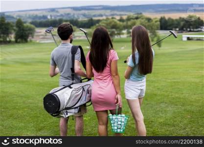 back view friends with golf equipment