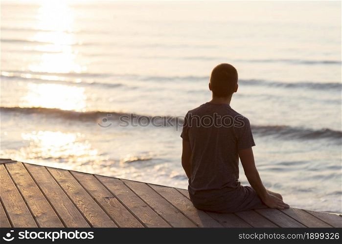 back view man relaxing beach outside with copy space 2. Resolution and high quality beautiful photo. back view man relaxing beach outside with copy space 2. High quality beautiful photo concept