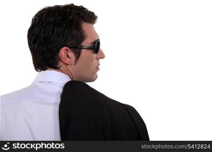 Back view of a smart man wearing sunglasses