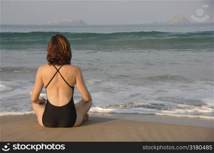 Back view of a woman doing yoga