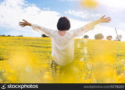 Back view of a woman in yellow field