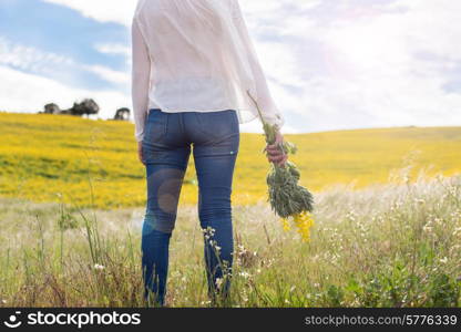 Back view of a woman in yellow field