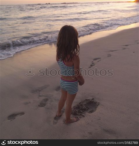 Back view of a young girl on beach