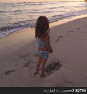 Back view of a young girl on beach