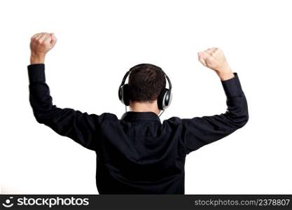 Back view of a young man listening music with headphones, isolated on white