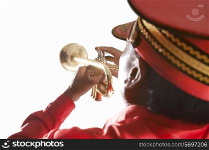 Back view of bandmaster playing on a trumpet