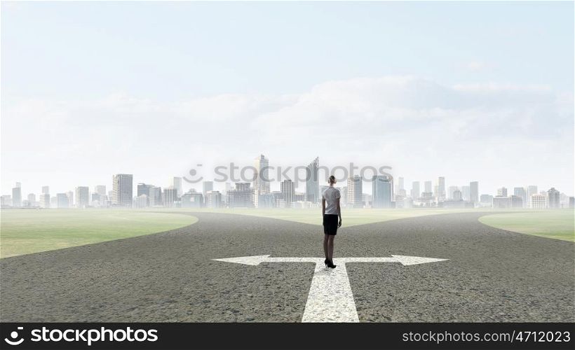 Back view of businesswoman standing on crossroads and making choice. Choose your way
