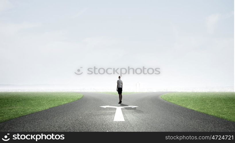 Back view of businesswoman standing on crossroads and making choice. Choose your way