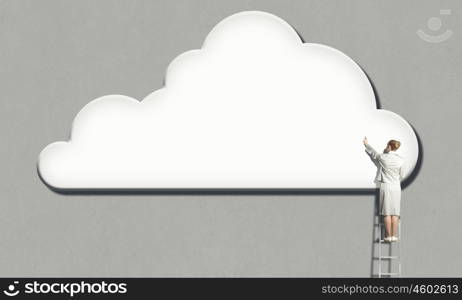 Back view of businesswoman standing on ladder and reaching to cloud. Computing concept